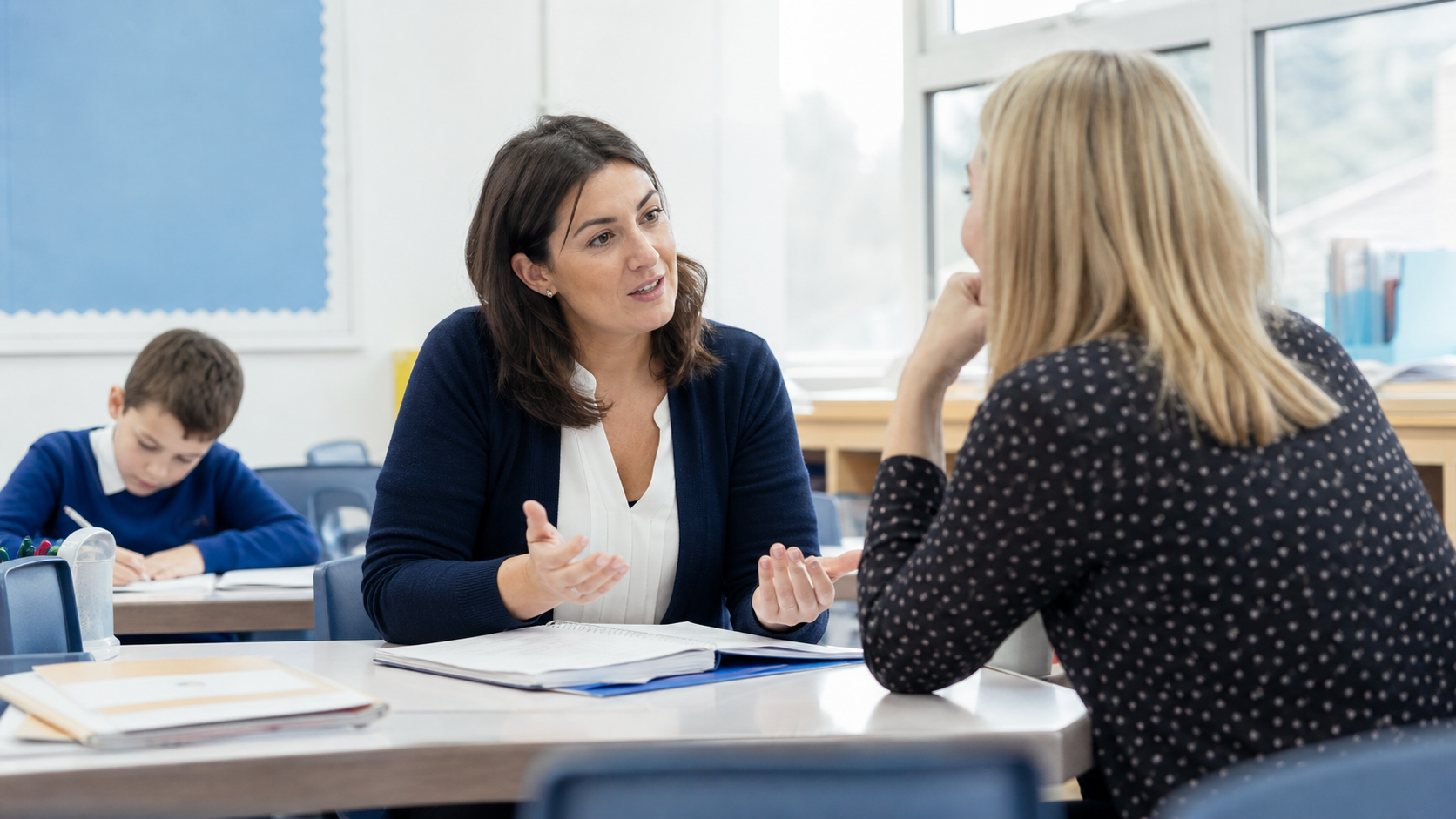 Parent and teacher having a supportive conversation about a Year 4 child's progress